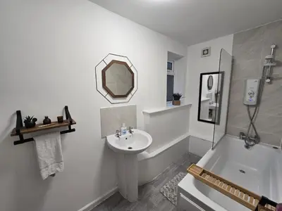 a white bathroom with a sink and a mirror at Room 2 Shared House 3 min from Stadium in Liverpool