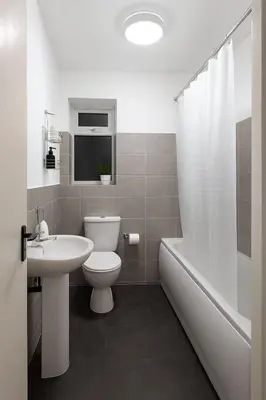 a bathroom with a toilet and a sink and a tub at Platt Bridge Contractor Stays-2 bedroom house in Abram