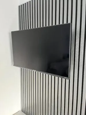 a corner of a wall with a television on it at The Stadium Hotel Anfield in Liverpool