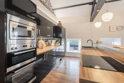 a large kitchen with a stove and a counter at Royal Oak Barn - Cartmel, Sleeps 8 NEW in Cartmel