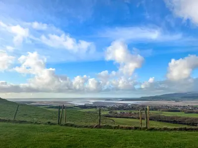 a view of the ocean from a hill with a fence at Birds - Uk48489 in Dalton in Furness