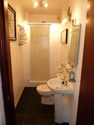 a bathroom with a white toilet and a sink at smithy lodge guest house in Leyland