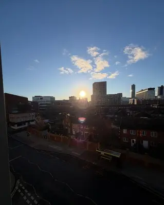 a view of a city skyline with the sun setting at Central Liverpool 2-Bed Balcony Apartment by StaySavvy Accommodation in Liverpool