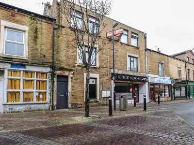 a brick building on the corner of a street at Morcombe Retreat in Morecambe