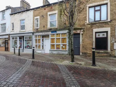 a cobblestone street in front of a building at Morcombe Retreat in Morecambe