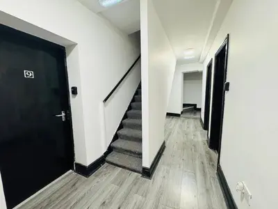 a hallway of an office with a black door and stairs at 12B Classy Bedroom in a Shared home at Pembroke in Liverpool