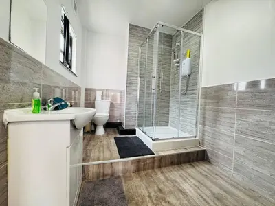 a bathroom with a shower and a sink and a toilet at 12A Charming Double Room in shared home at Pembroke in Liverpool