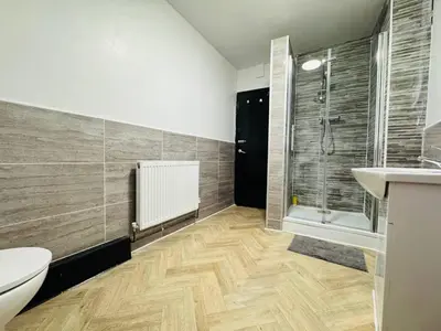 a bathroom with a shower and a toilet and a sink at 12A Charming Double Room in shared home at Pembroke in Liverpool