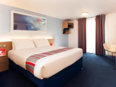 a bedroom with a large bed in a hotel room at Travelodge Liverpool Stonedale Park in Liverpool