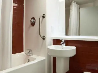 a bathroom with a sink and a toilet and a tub at Travelodge Lytham St Annes in Saint Annes on the Sea