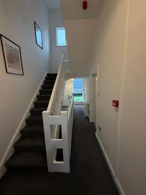 a staircase in a house with a white stair case at City Centre 4 Bedroom Apartment with Terrace Sleeps 10 by StaySavvy Accommodation in Liverpool