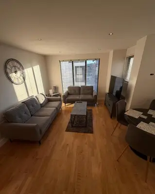a living room with a couch and a tv at 2-Bed City View with Balcony Liverpool by StaySavvy Accommodation in Liverpool