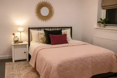 a bedroom with a bed and a mirror on the wall at Modern One Bedroom Flat near Anfield Stadium with Parking in Liverpool