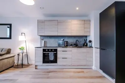 a kitchen with a stove and a microwave at Modern Central Preston Apt King Bed & Smart TV in Preston