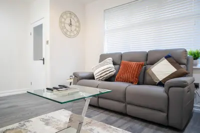 a living room with a couch and a glass table at Luxury Preston Home 3 Beds Sleeps 6 in Preston