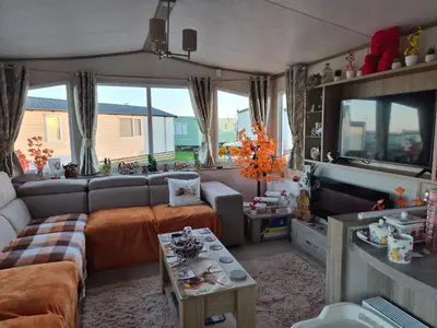 a living room with a couch and a tv at Hills residence in Heysham