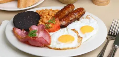 a plate of breakfast food with eggs beans and bacon at Scarisbrick Hotel in Southport