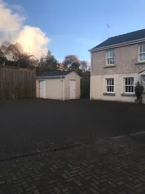 a house with a fence and a brick driveway at 5 Laurel Court in Ulverston