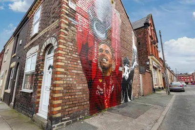 a mural of a man on the side of a brick building at 44 Stonehill Street in Liverpool