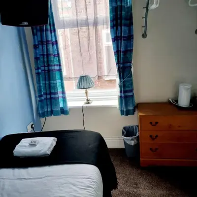 a bedroom with a bed and a window at The New Osterley Hotel in Blackpool
