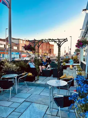 a patio with tables and chairs on a building at Granville Hotel in Blackpool
