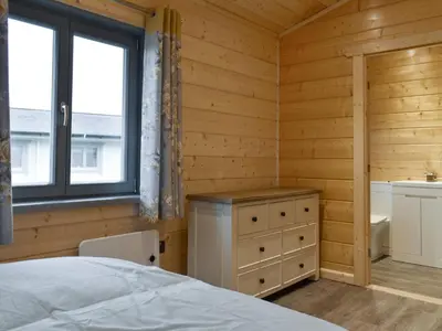 a bedroom with a bed and a sink and a window at Cedar Lodge - Uk30008 in Lindal in Furness