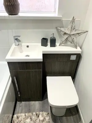 a bathroom with a white sink and a toilet at Victory hot tub house in Blackpool
