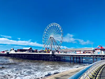 a ferris wheel on a pier next to the water at Chelsea Suite Sasco Apartments in Blackpool