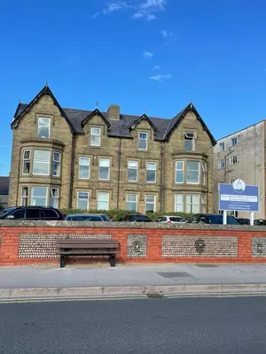 a building with a bench in front of it at Beach Shore - SEA VIEWS in Lytham St Annes