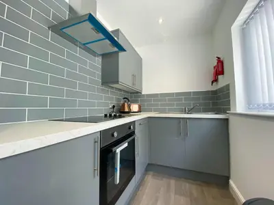 a kitchen with a sink and a dishwasher at Kensington Suite Sasco Apartments in Blackpool