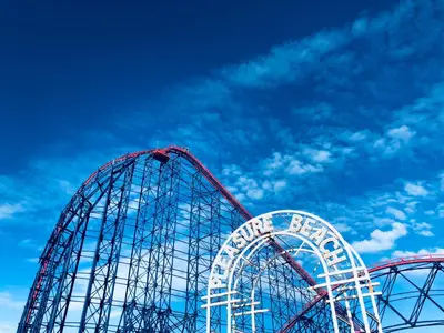 two roller coaster rides with a blue sky in the background at Mayfair Suite - 3x Bathrooms Close to Seafront in Blackpool