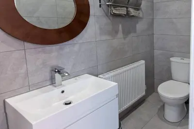 a bathroom with a sink and a toilet and a mirror at Blackbird Luxury 2 Bed Accommodation Room 7 in Blackpool