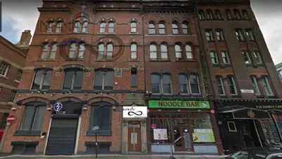 a large brick building on the corner of a street at Contractor Bookers Liverpool City Centre in Liverpool