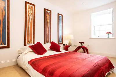a bedroom with a large bed with red pillows at Finest Retreats - Walney Island Lighthouse in Rampside