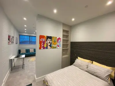 a bedroom with a bed with a large headboard at Kempston Suites Liverpool Apartment 1 in Liverpool
