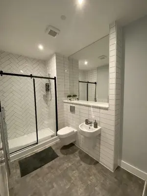 a bathroom with a toilet and a shower and a sink at Kempston Suites Liverpool Apartment 4 in Liverpool
