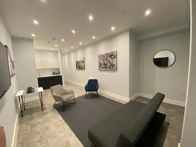 a living room with a couch and a chair at Kempston Suites Liverpool Apartment 4 in Liverpool