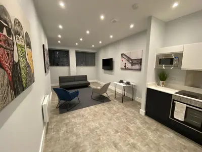 a living room with a couch and a table and chairs at Kempston Suites Liverpool Apartment 5 in Liverpool