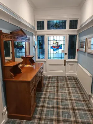 a bathroom with a vanity and stained glass windows at Eden Vale Ground Floor Sea View Apartment in Morecambe