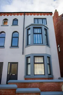 a white house with black windows at Withnell Stays - Apartment Two in Blackpool