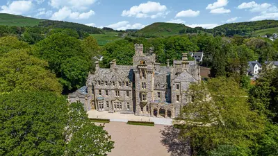 an old castle in the middle of a forest at William Tower Suite Stone Cross Mansion in Ulverston