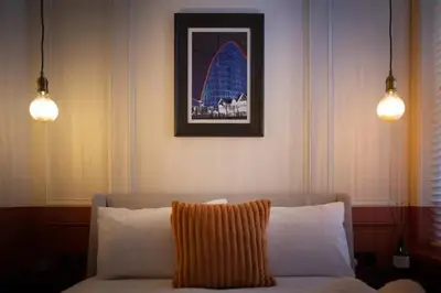 a living room with a couch and two lights at Capri Stays - Apartment One in Blackpool