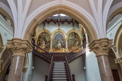 a staircase in a building with a painting on the wall at The Myles Suite Stone Cross Mansion in Ulverston