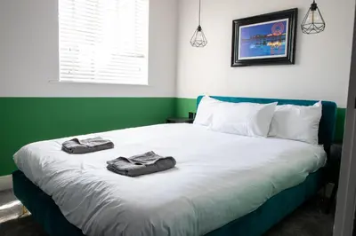 a bedroom with a bed with two towels on it at Withnell Stays - Apartment Five in Blackpool