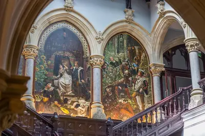 a large painting on the wall of a building with stairs at The Margaret Suite Stone Cross Mansion in Ulverston