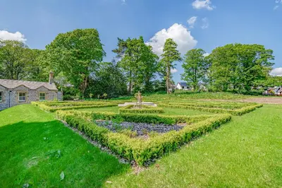 a garden in front of a house at Alice House Stone Cross Mansion in Ulverston