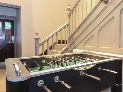 a game room with a chess board in front of a staircase at The Florence Suite Stone Cross Mansion in Ulverston