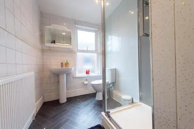 a bathroom with a toilet and a sink and a shower at Beech Apparent lovely spacious double room in Liverpool