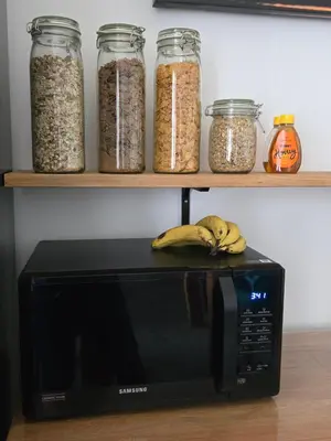 a black microwave with some bananas on top of it at Victorian Renovation Room 3 in Liverpool