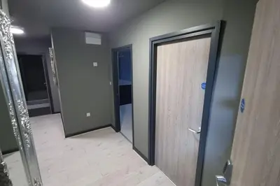 a room with two doors and a wooden floor at City CTR DJ party apartment - ibiza suite in Liverpool